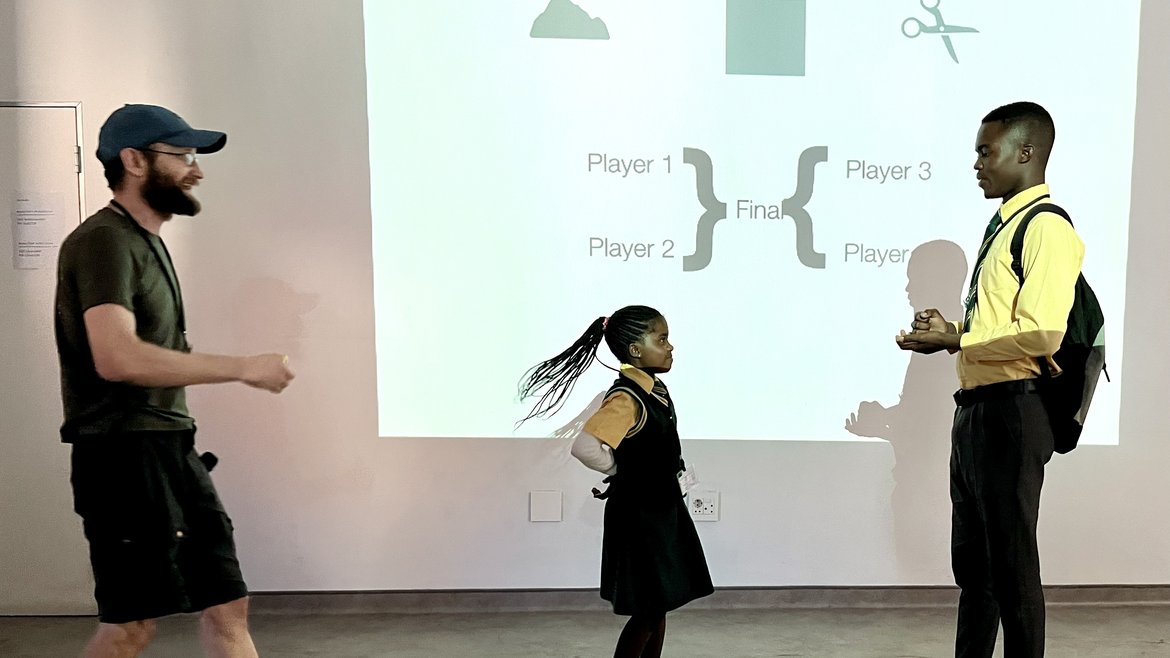 Participants playing Rock Paper Scissors